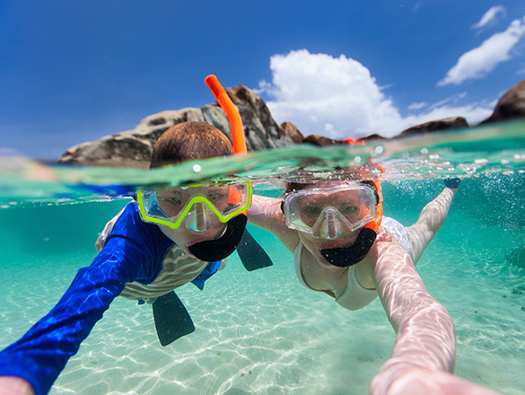 Family snorkeling in tropical water